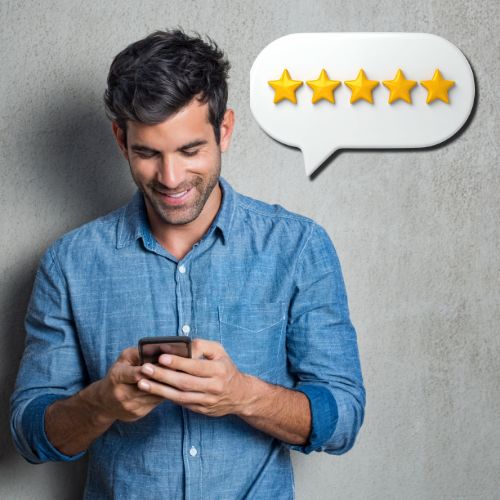 man smiling while looking at his phone with a five star review speech bubble, representing positive customer feedback and online reviews
